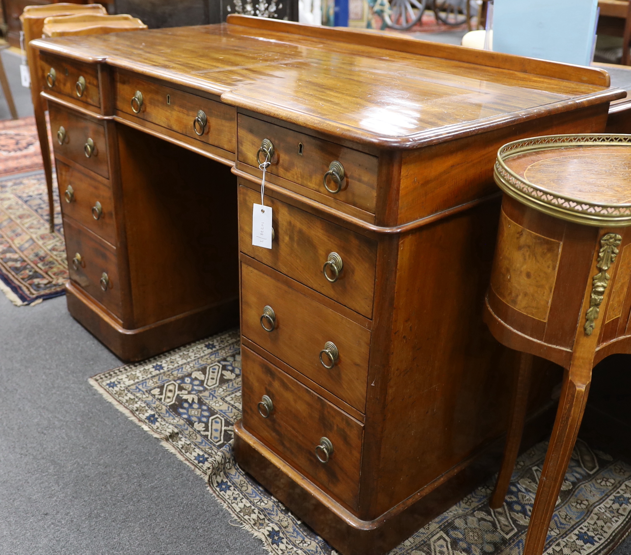 A Victorian mahogany Heal & Son, London inverse breakfront pedestal desk, width 122cm, depth 59cm, height 76cm